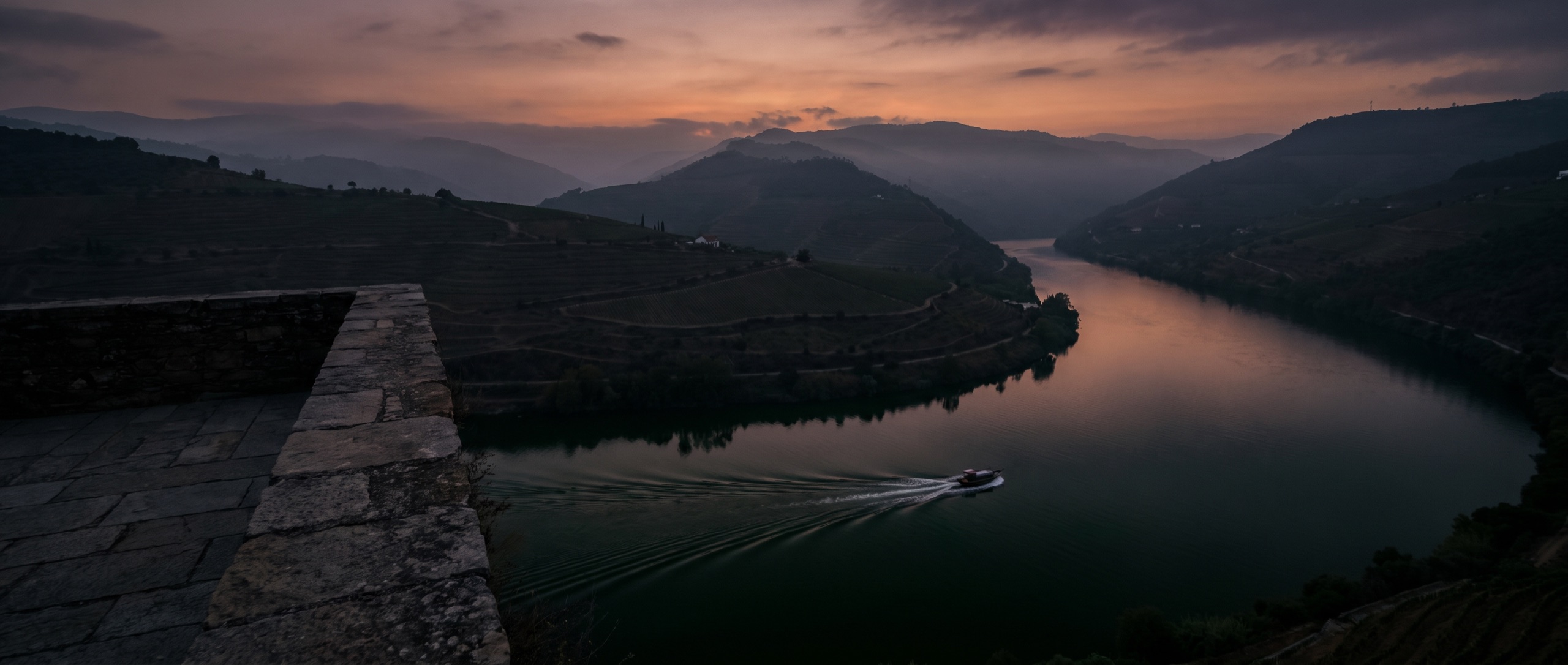 Curva do rio Douro ao anoitecer vista dos socalcos altos, colinas em silhueta